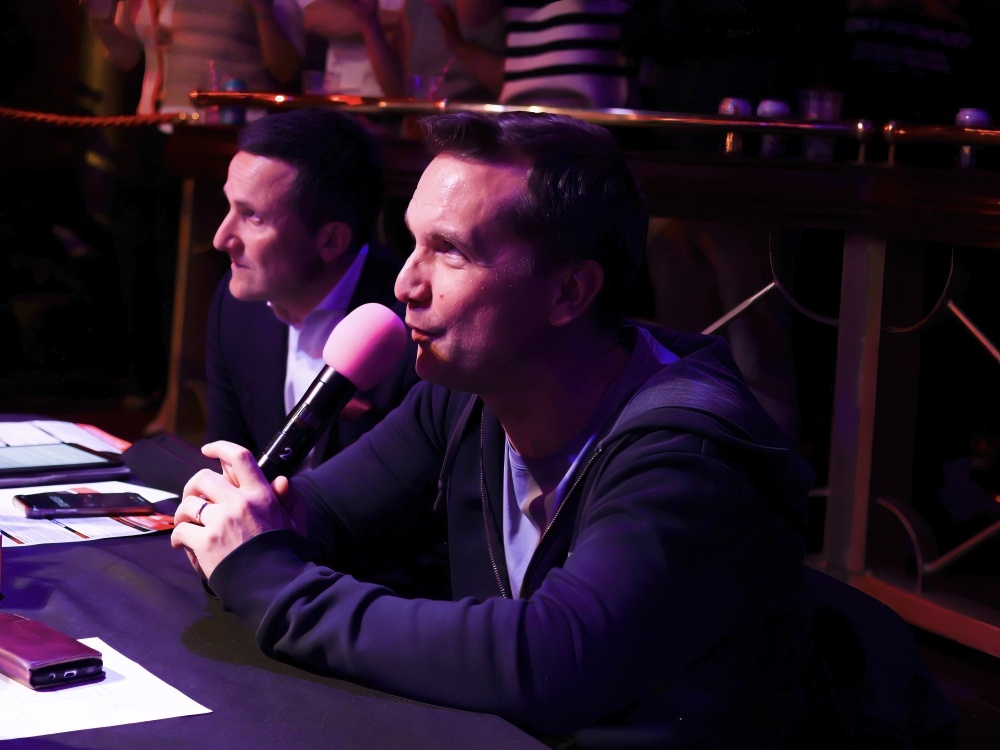 Commentator Andy Clarke holding the microphone at the Lily Fight Night