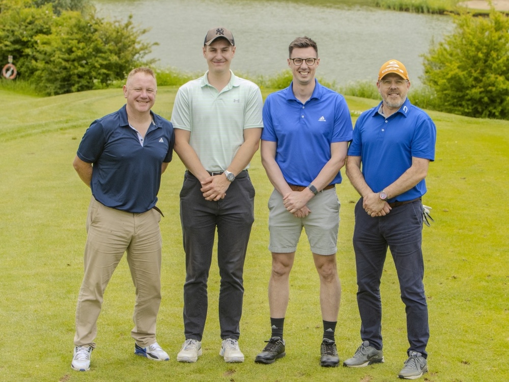 Four players lined up on the green at the Lily South West Golf Day