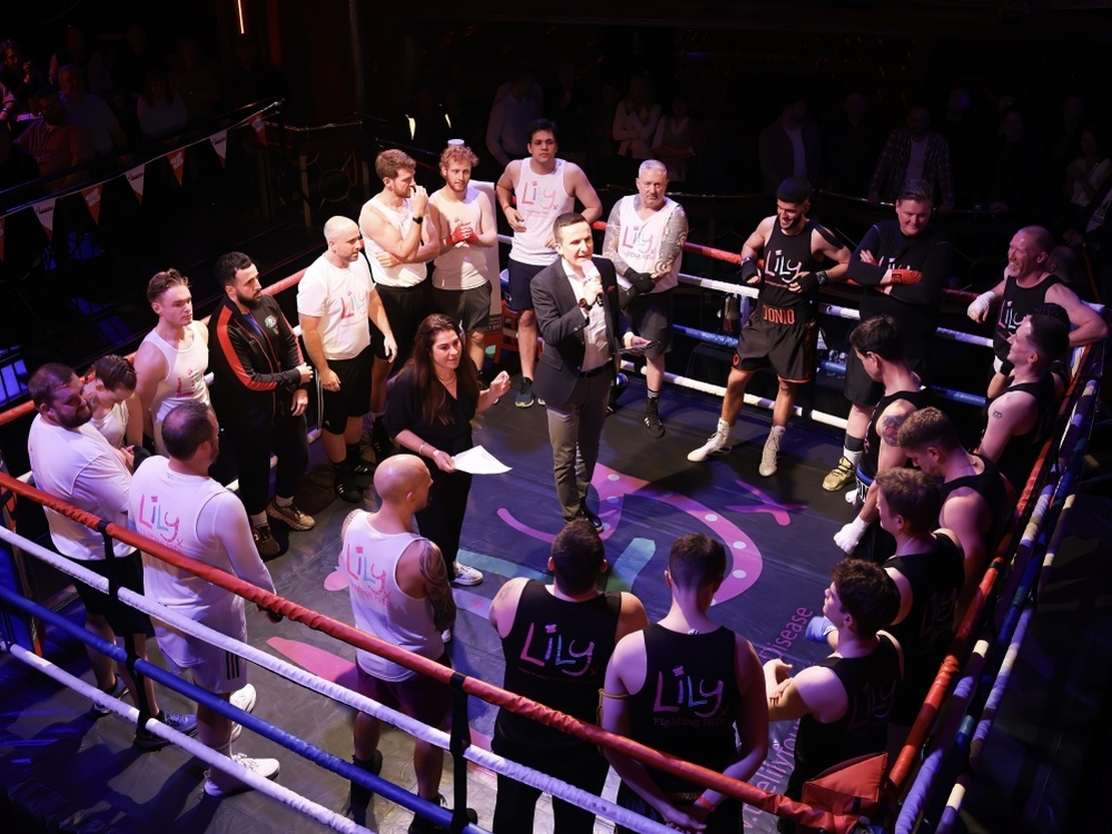 Lily Fight Night boxers stand in the ring with charity founder, Liz