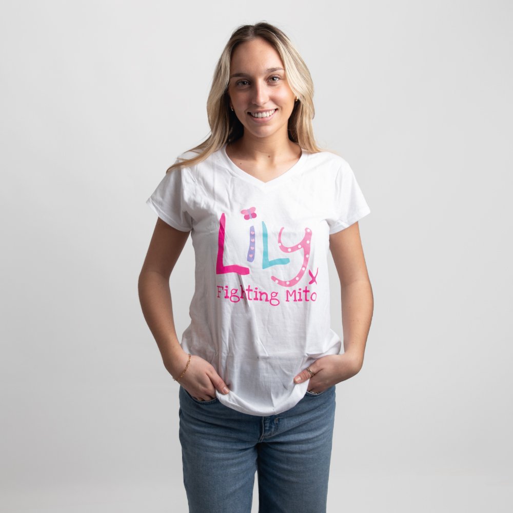 A smiling woman in a white v-necked t-shirt featuring the Lily Foundation logo and fighting mito underneath.