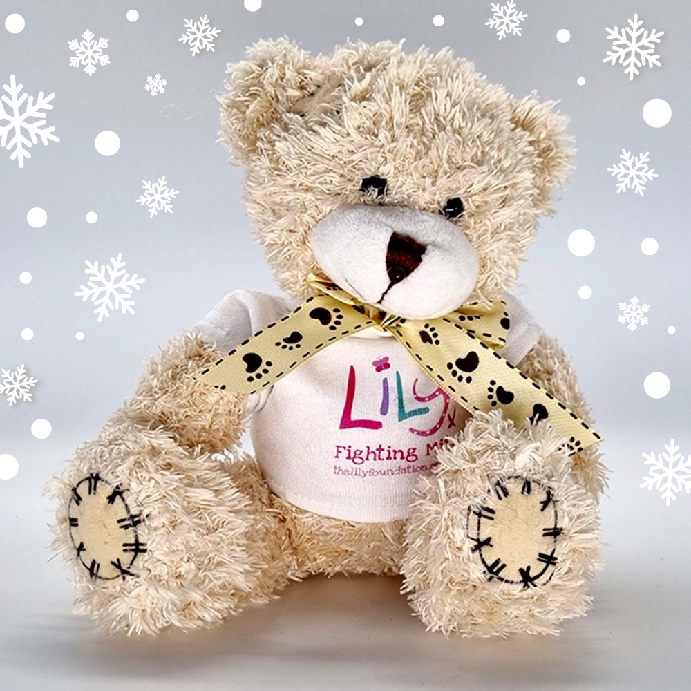 A beige teddy bear with a bow and a white t-shirt featuring the Lily Foundation logo and the words fighting mito.