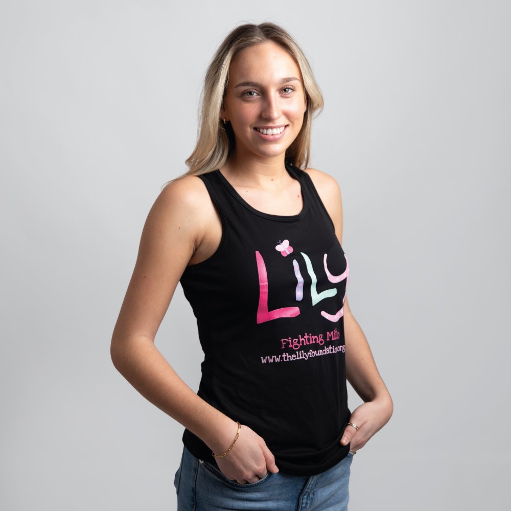 A smiling woman in a black vest featuring the Lily Foundation logo and fighting mito underneath.