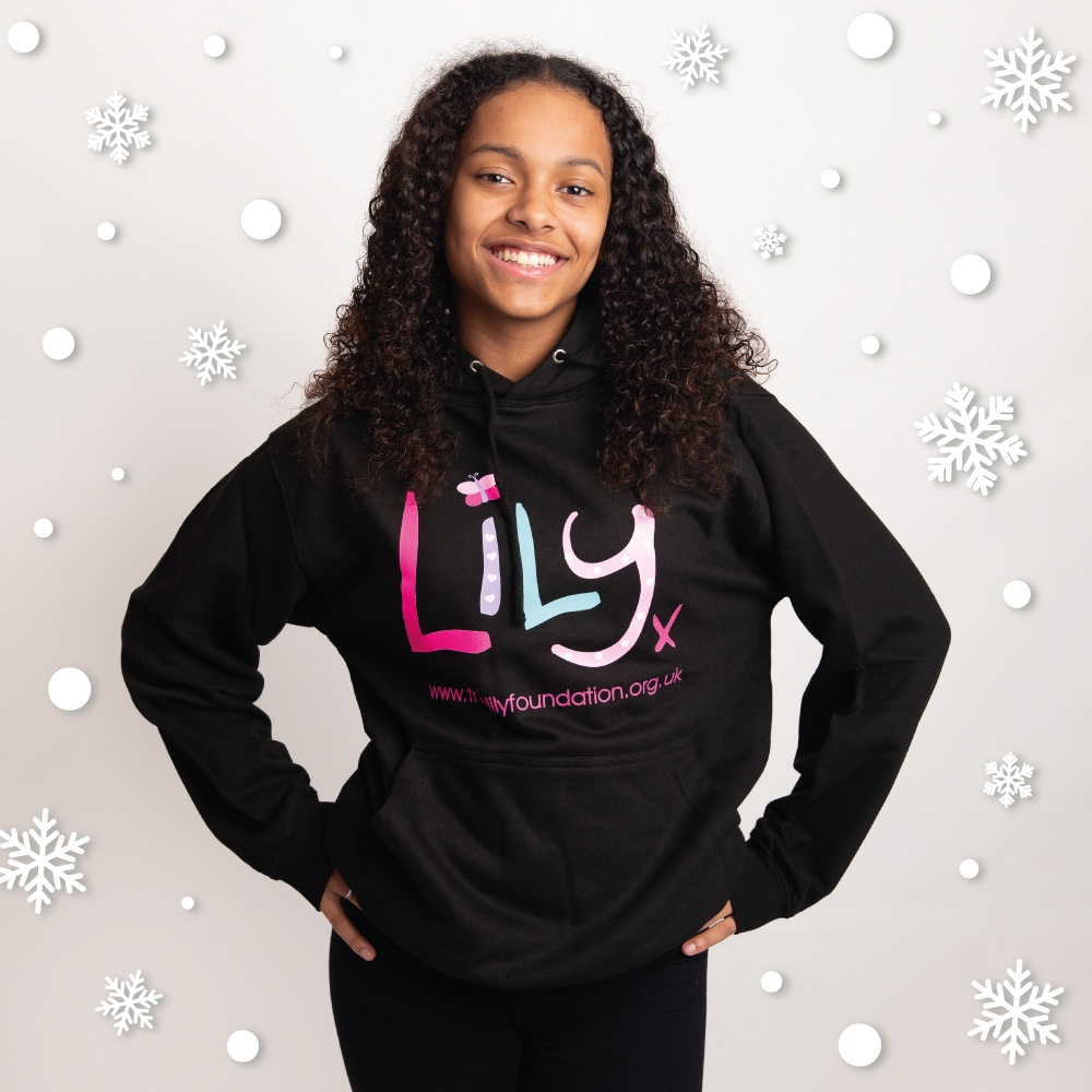 A young girl in a black hoodie featuring the Lily Foundation logo and website address.