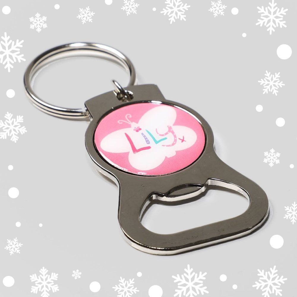 A metal bottle opener with a pink circle in the center, featuring the Lily Foundation logo.