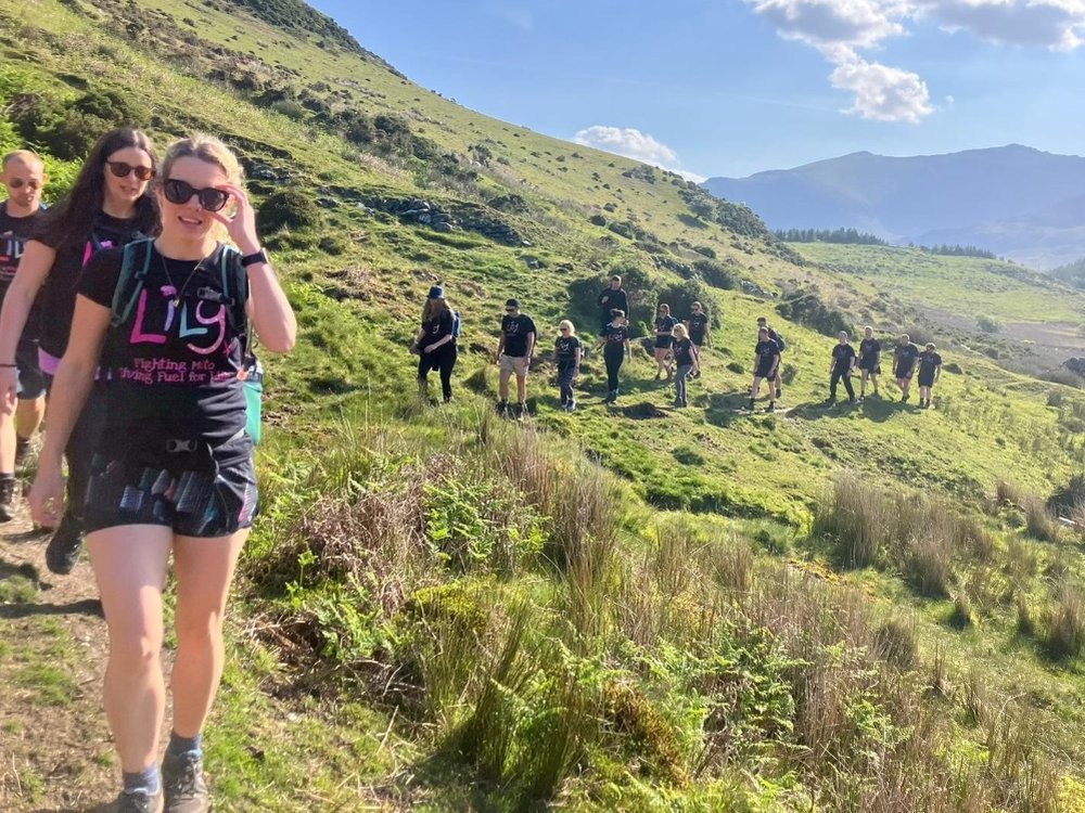 Ultra Challenge Series 2025 - A group of people in Lily tops enjoying an Ultra Challenge on a sunny hillside