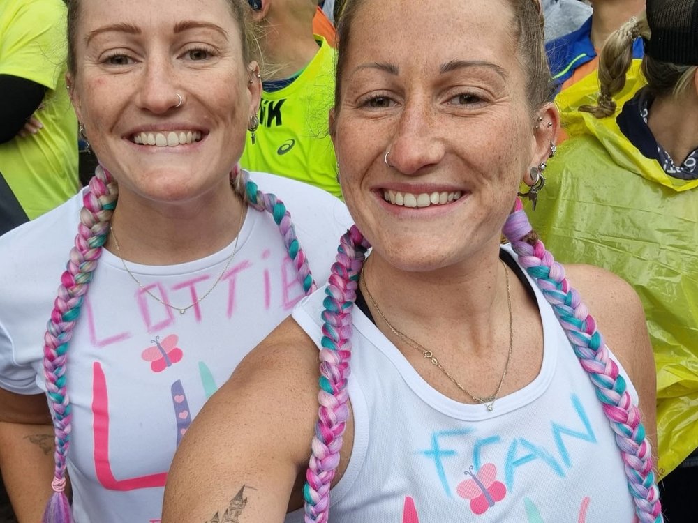 Manchester Marathon 2025 - Two smiling ladies in Lily Foundation running vests