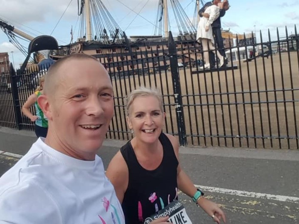 Great South Run 2025 - A man and woman in Lily Foundation tops running the Great South Run for mitochondrial disease