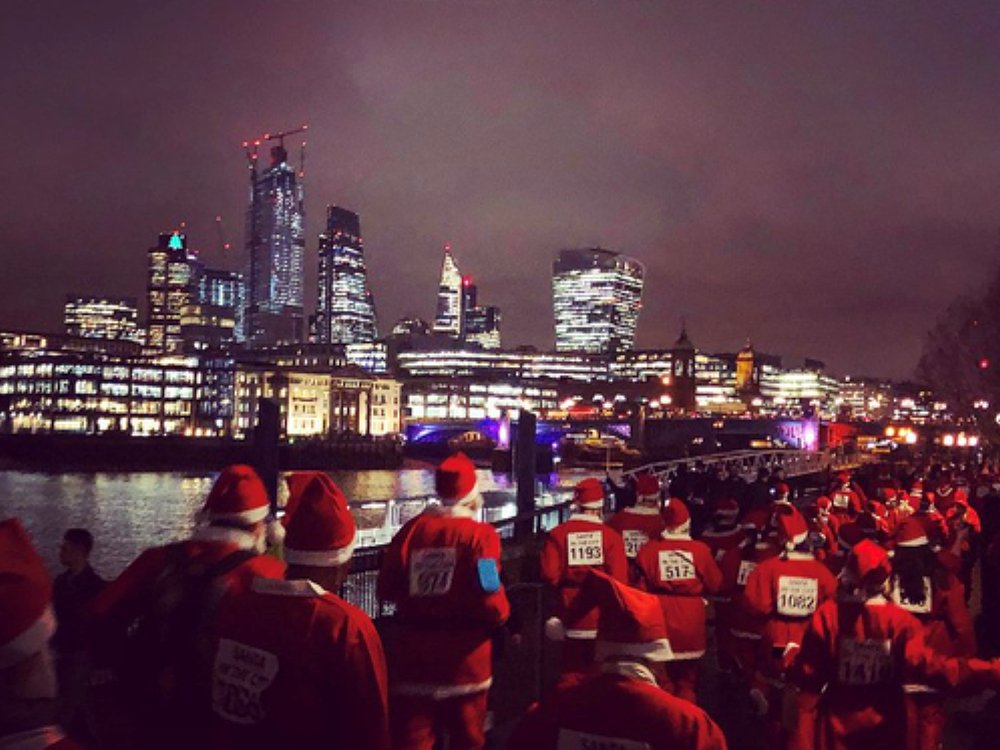 Runners in Santa suits taking part in a London Santa run for charity