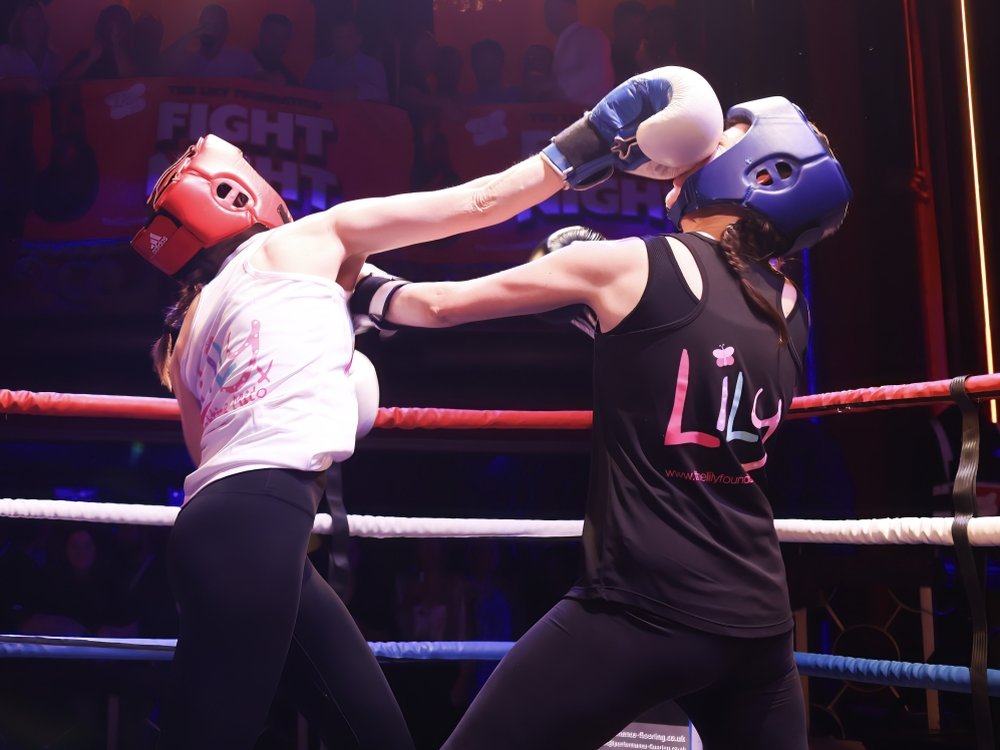 Two boxers in the ring at The Lily Foundation charity boxing event