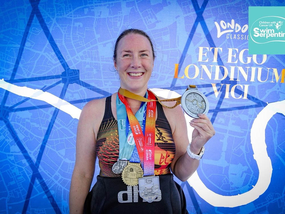 Swim Serpentine 2025 - Woman holding a medal having completed Swim Serpentine for The Lily Foundation