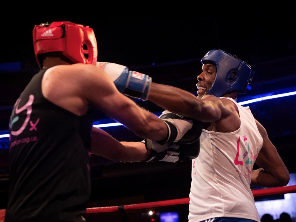 Lily Fight Night 2025 - Two boxers in Lily tops throwing punches at The Lily Foundation's Fight Night