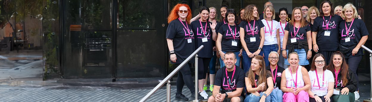 Lily staff in lily Tshirts sitting on tiered steps