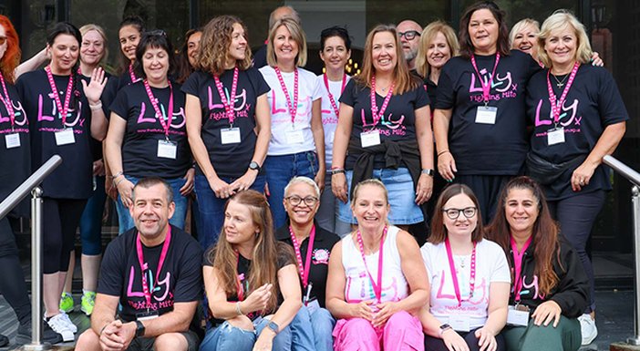 Lily staff in lily Tshirts sitting on tiered steps