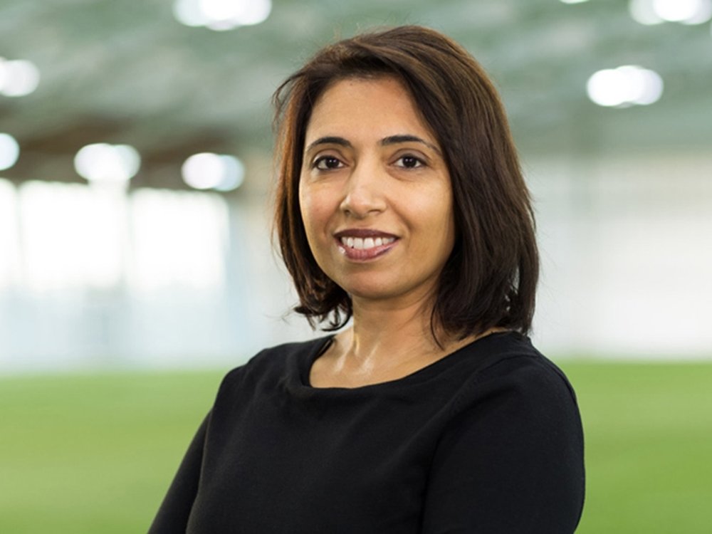 Rupinder Bains, lady with dark shoulder length hair and a black long sleeved top