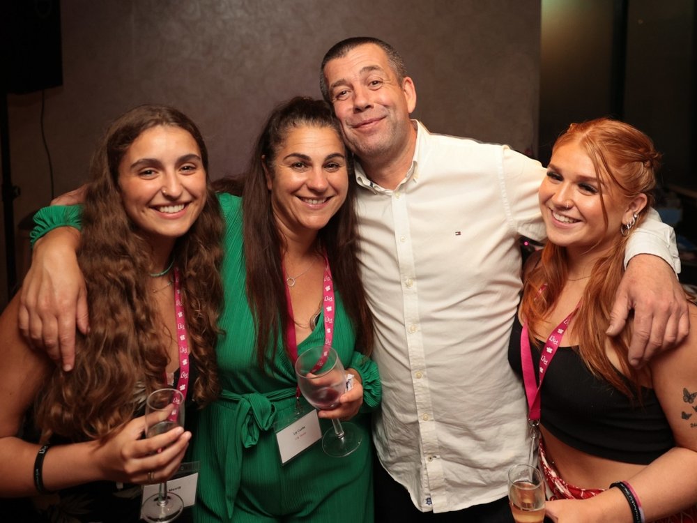 Lily founder Liz with her partner and their two daughters standing with their arms around each other