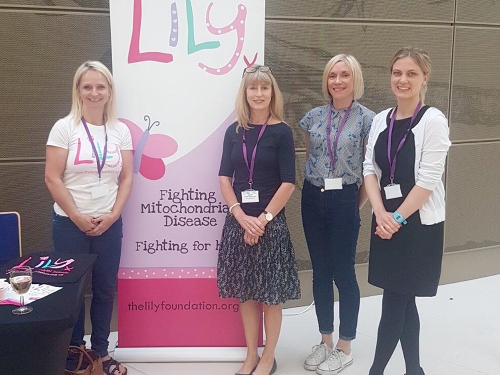 4 Women stand side by side in front of a lily foundation sign