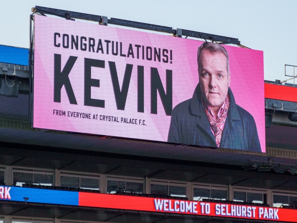 A large scoreboard with a picture of Kevin Day and the word congratulations