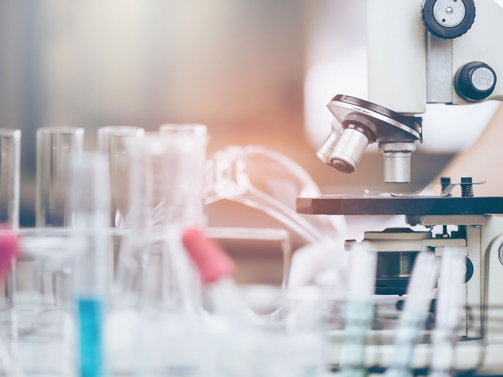 close up of a microscope and research lab equipment