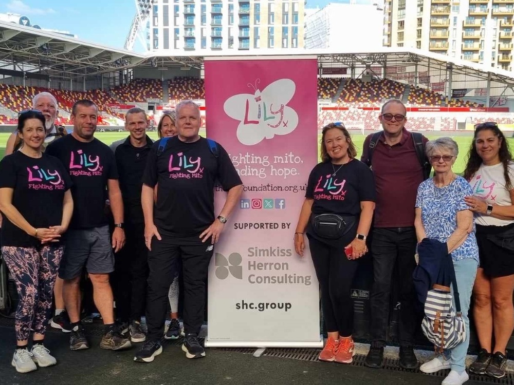 Kevin and fellow walkers with a Lily banner on the stands at Brentford