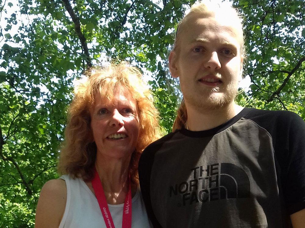 A woman and young man stand next to each other in the sunshine