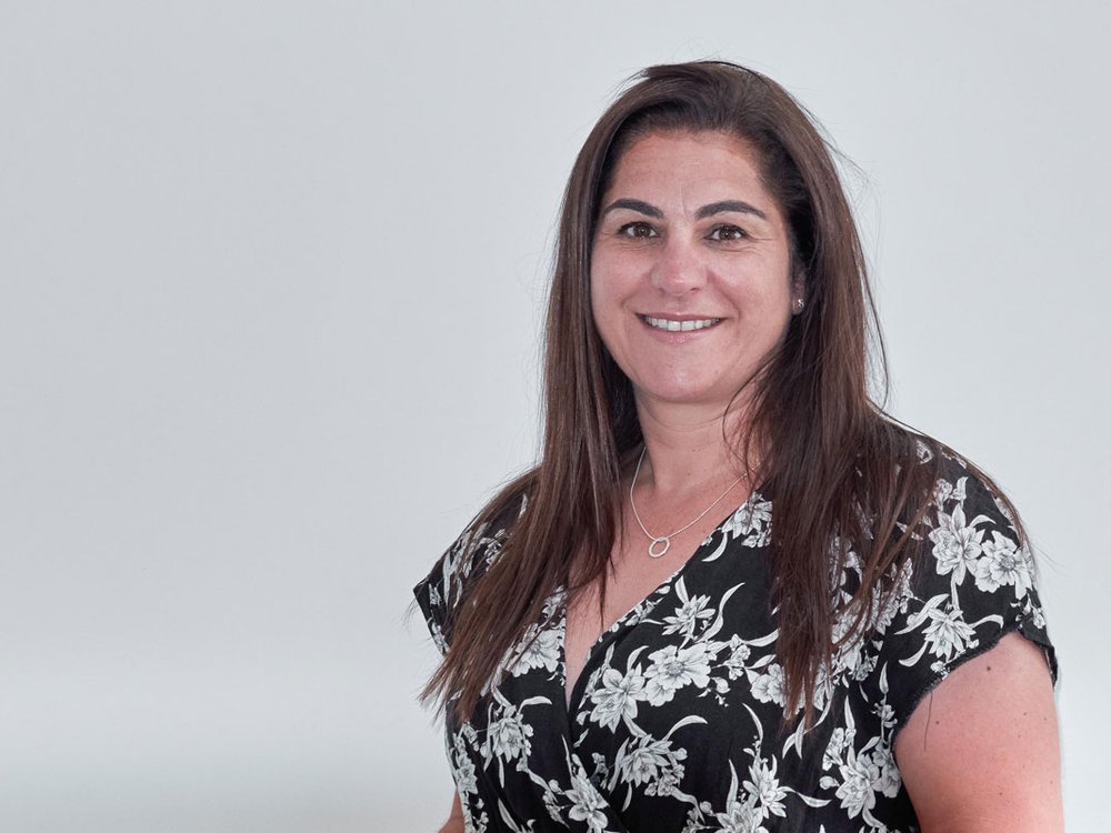 Liz Curtis, CEO of The Lily Foundation wearing a floral dress