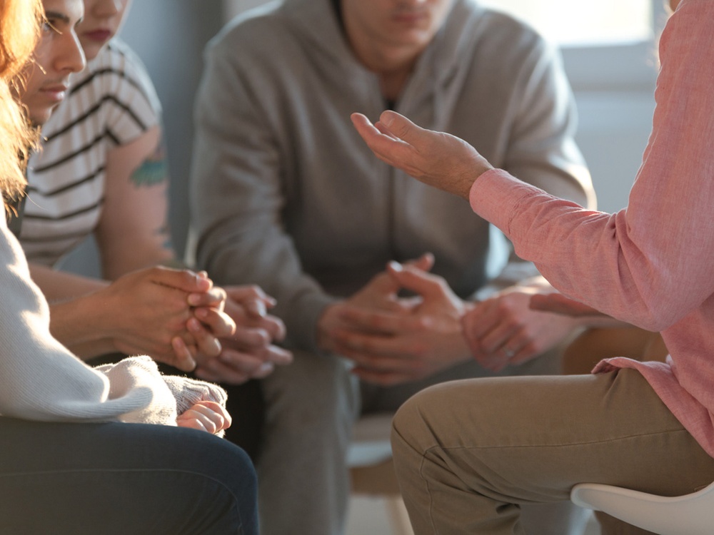 Three people sat facing each other