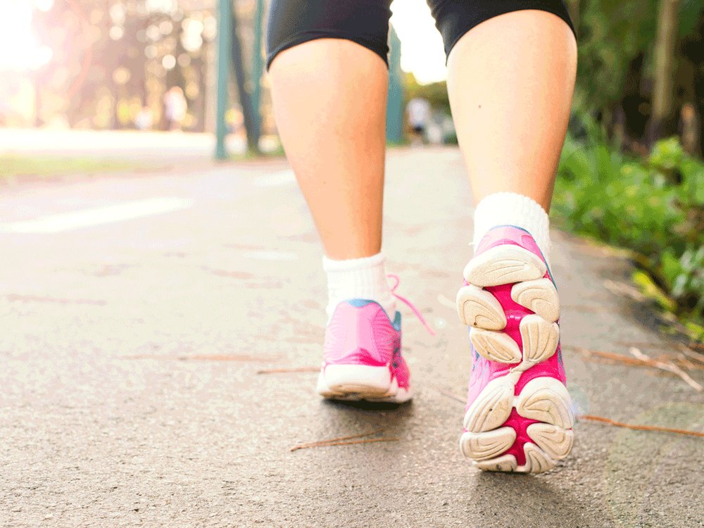 The back of a person legs in capri running tights and pink trainers