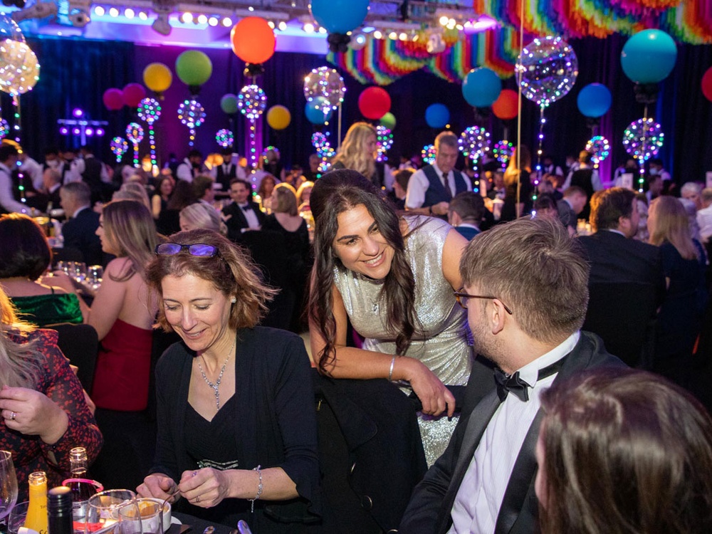 Lily CEO Liz chatting with a guest at his table