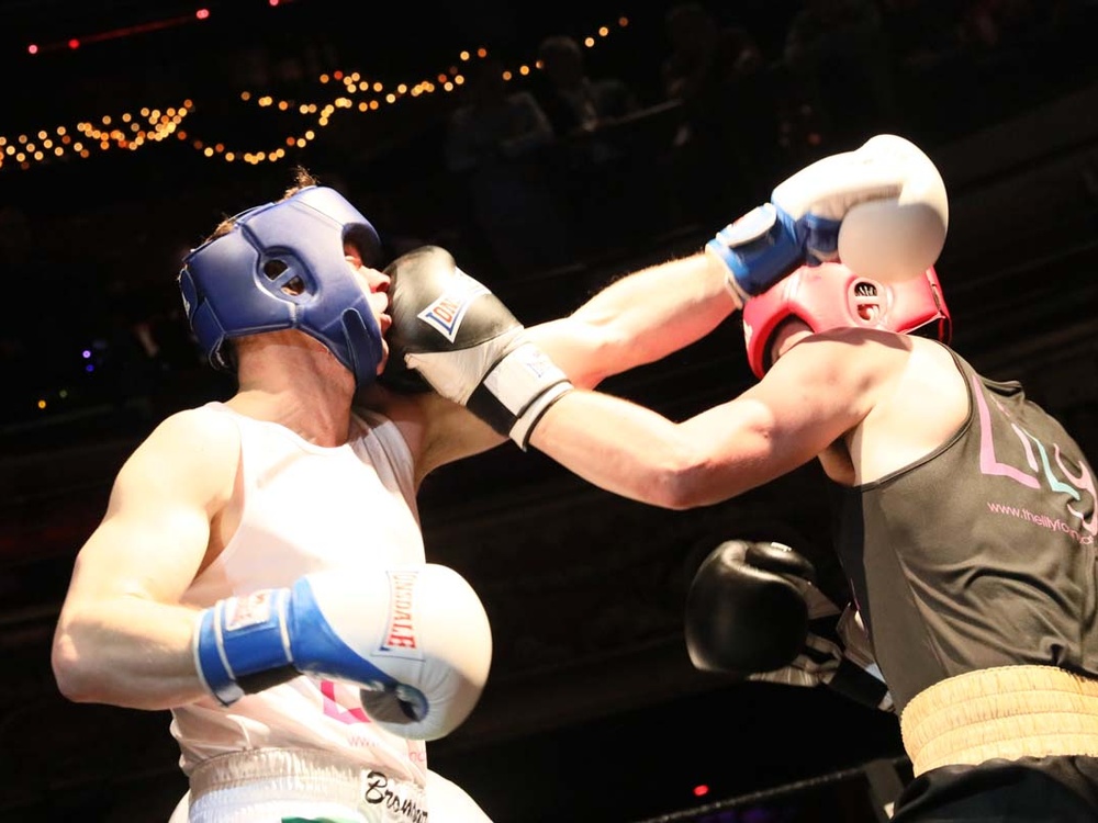 Two boxers in Lily vest taking a punch at one another