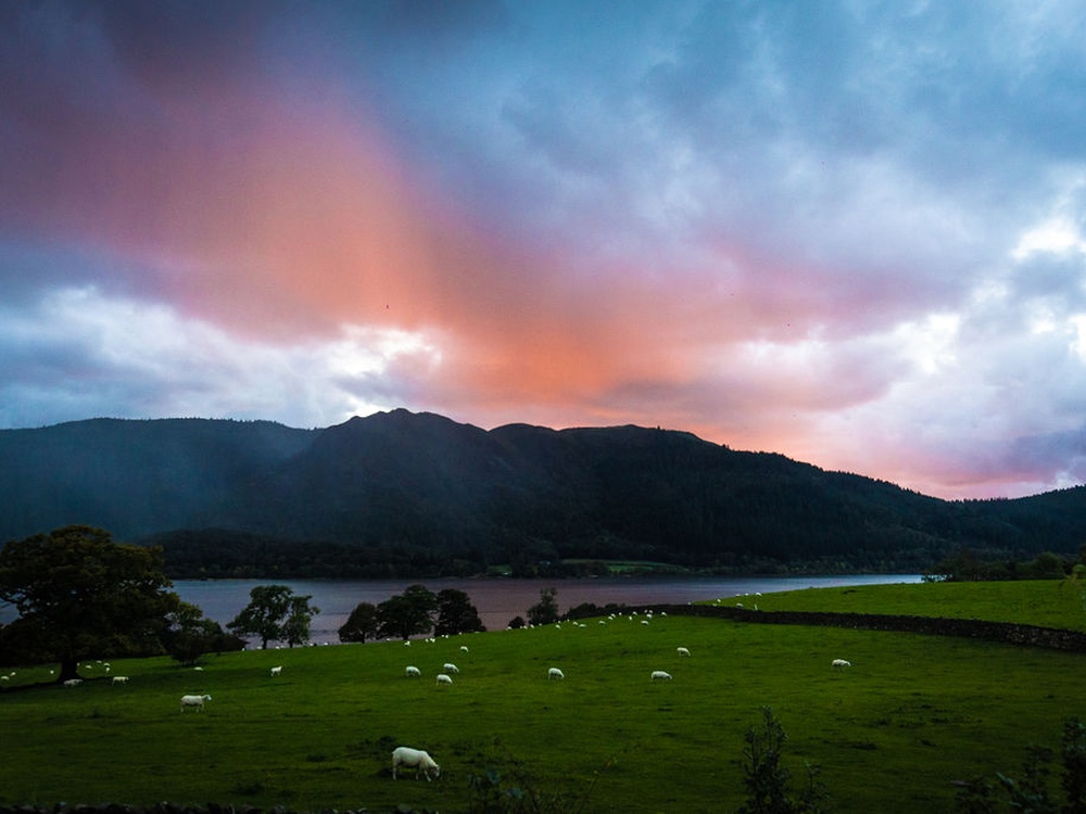 A beautiful sunset over the lake and hill from the Calvert Trust building