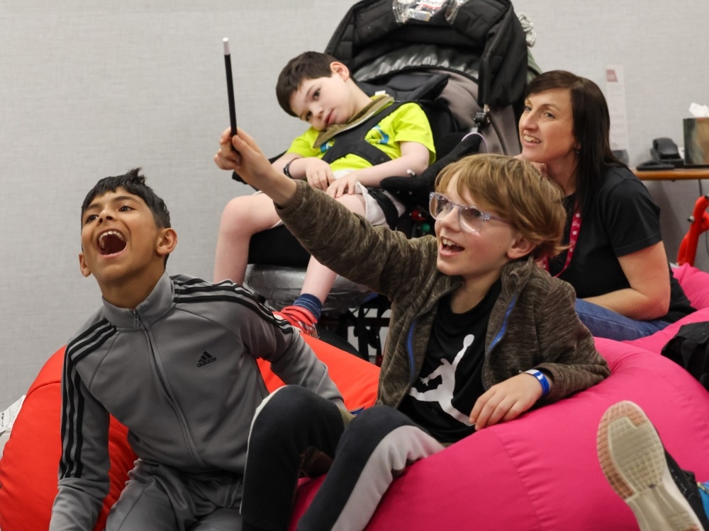 Young mito warriors and their siblings sitting on bean bags laughing