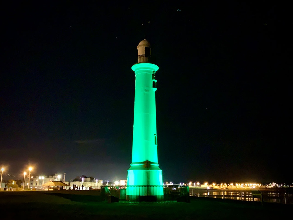 Seaburn Lighthouse lit up green in the night sky