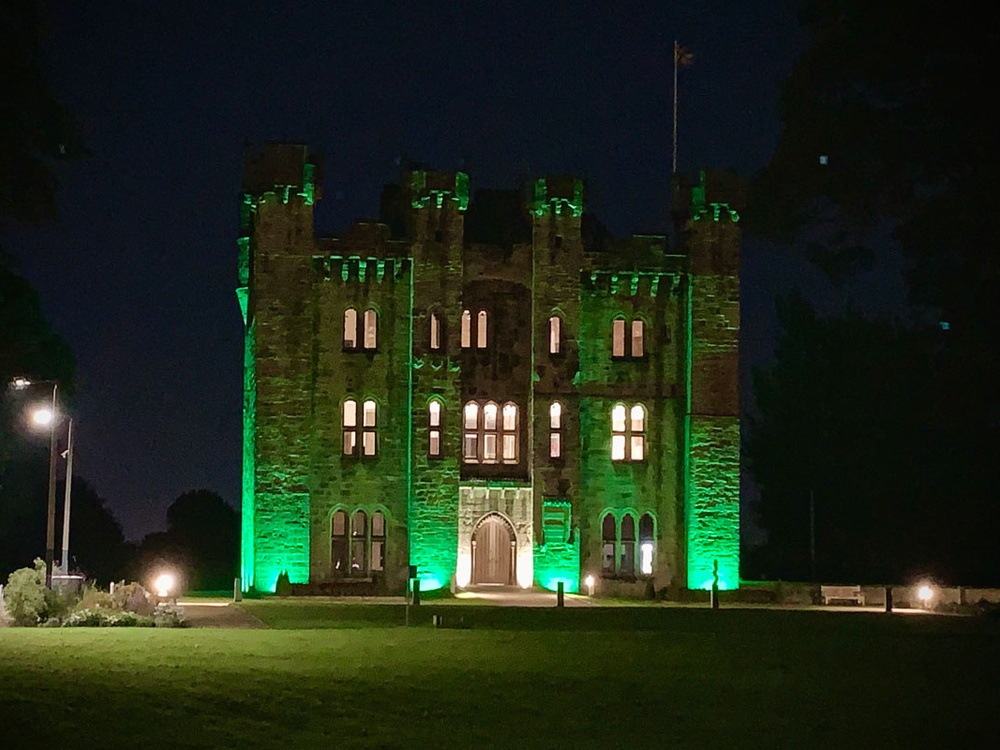 Hylton Castle in Sunderland lit up green against the dark sky