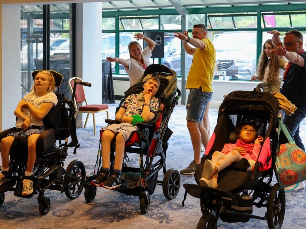 3 young adult mito warriors in wheelchairs at the Lily Family Support Weekend