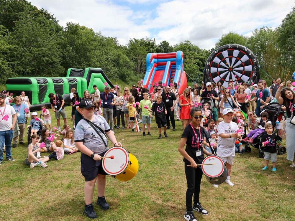 Lily families gather outdoors with drums and a parade at the Lily weekend