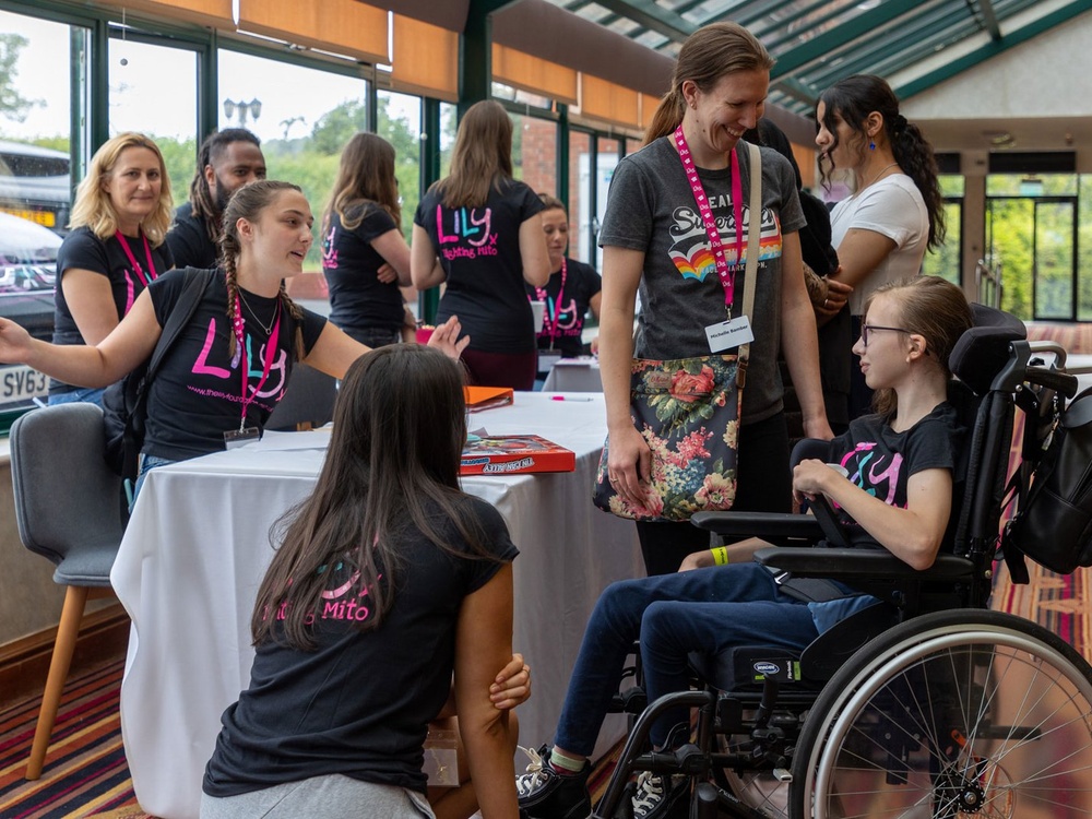 Children and Lily volunteers gathered around a table