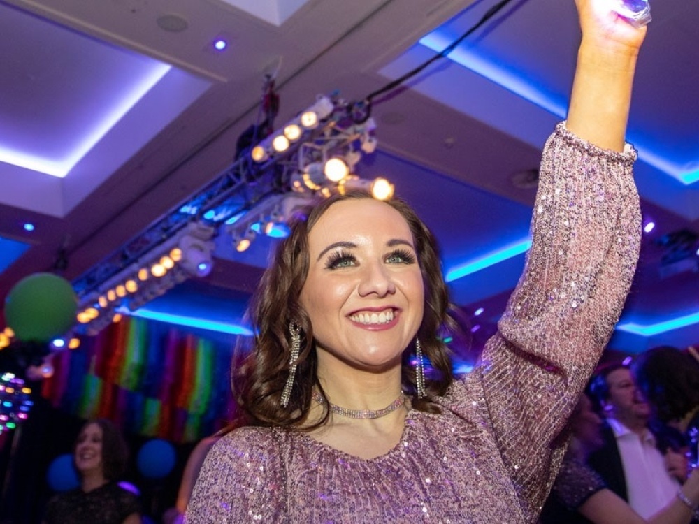 A young adult mito warrior in a sparkly dress at the Lily charity ball